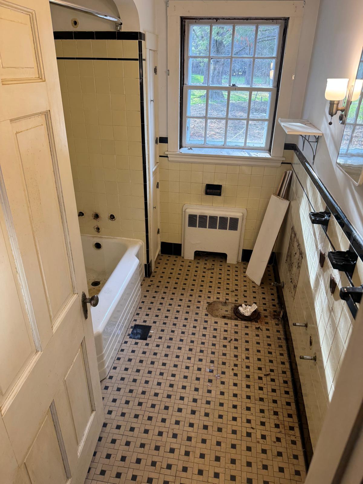 Before — bathroom stripped back to the studs