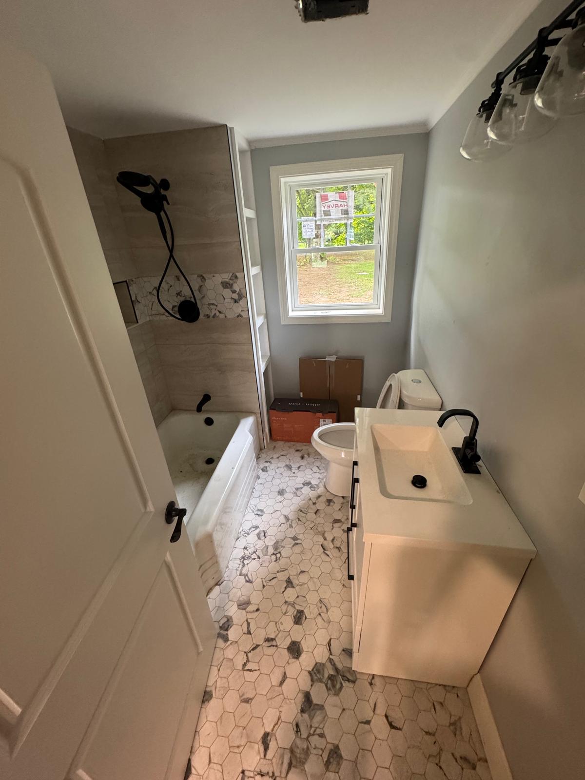 Bathroom remodel — hexagon floor, marble-look shower walls and freestanding tub