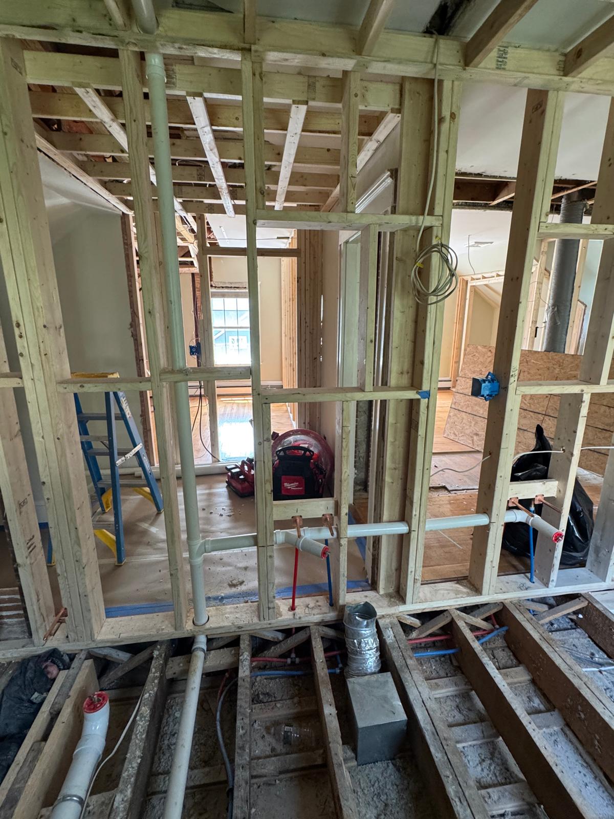 During — new subfloor framing, wall studs and PVC drain lines