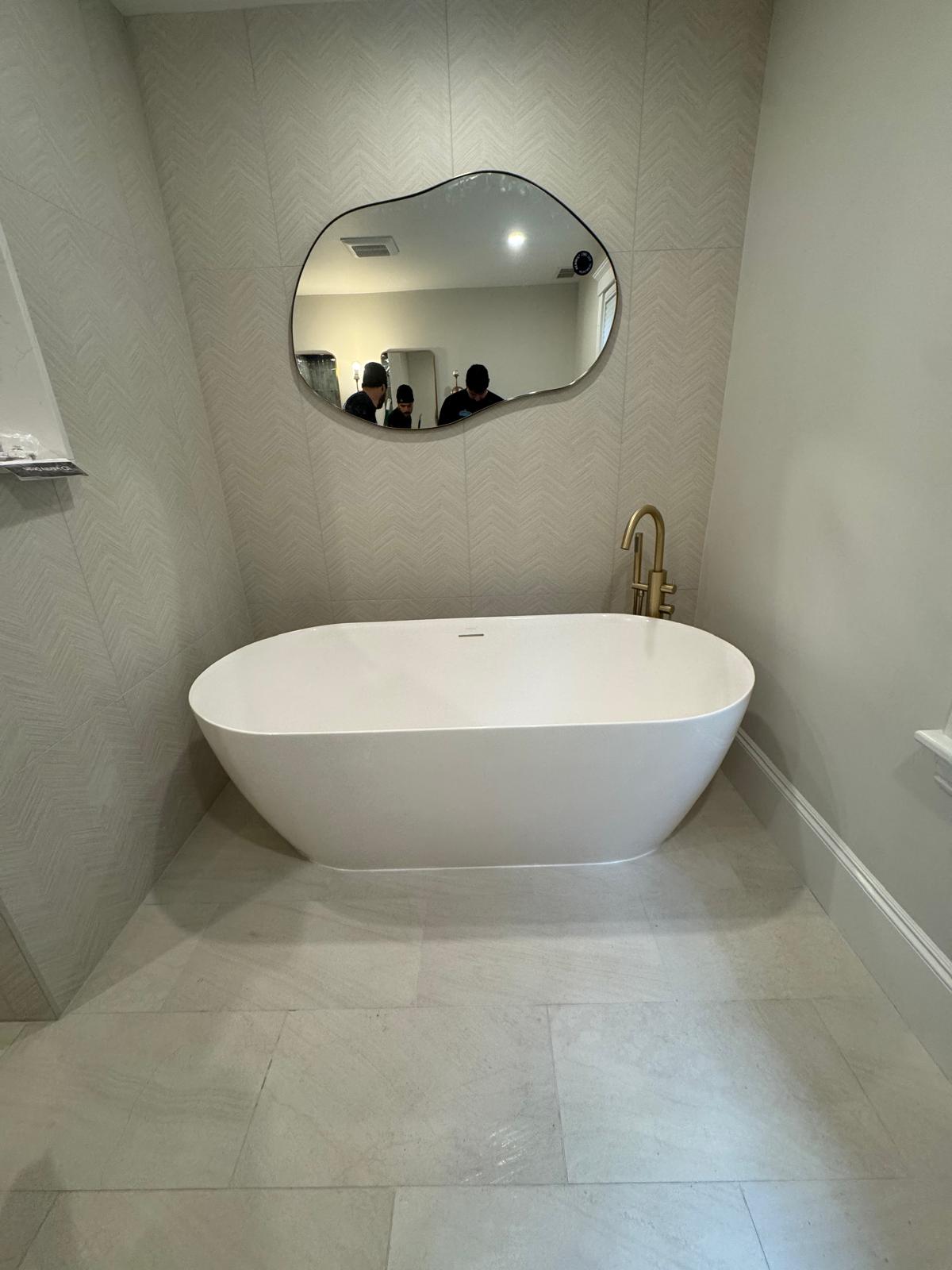 Master bathroom — freestanding soaking tub with gold floor-mount filler