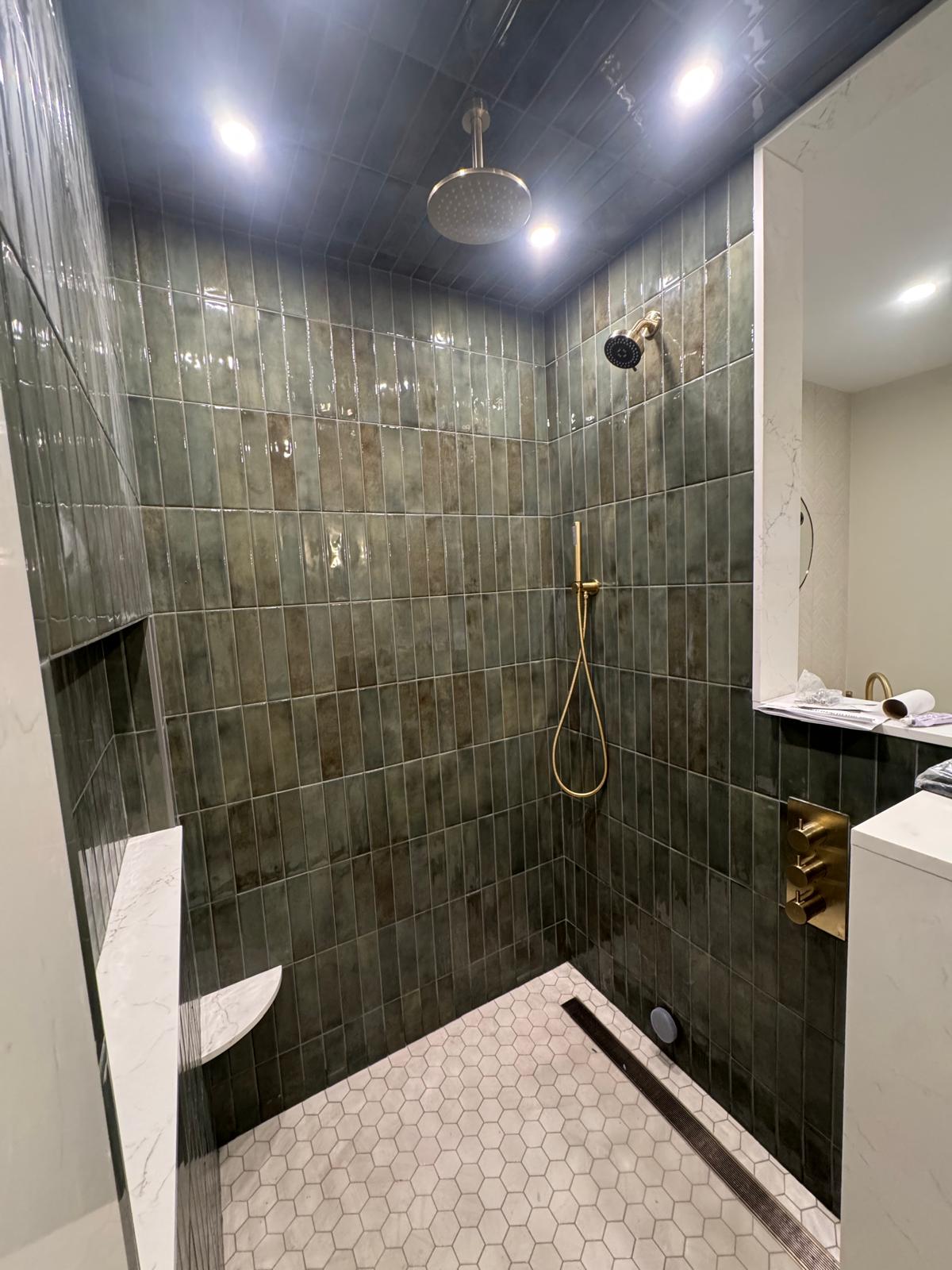 Master bathroom — brushed gold fixtures and rain shower head