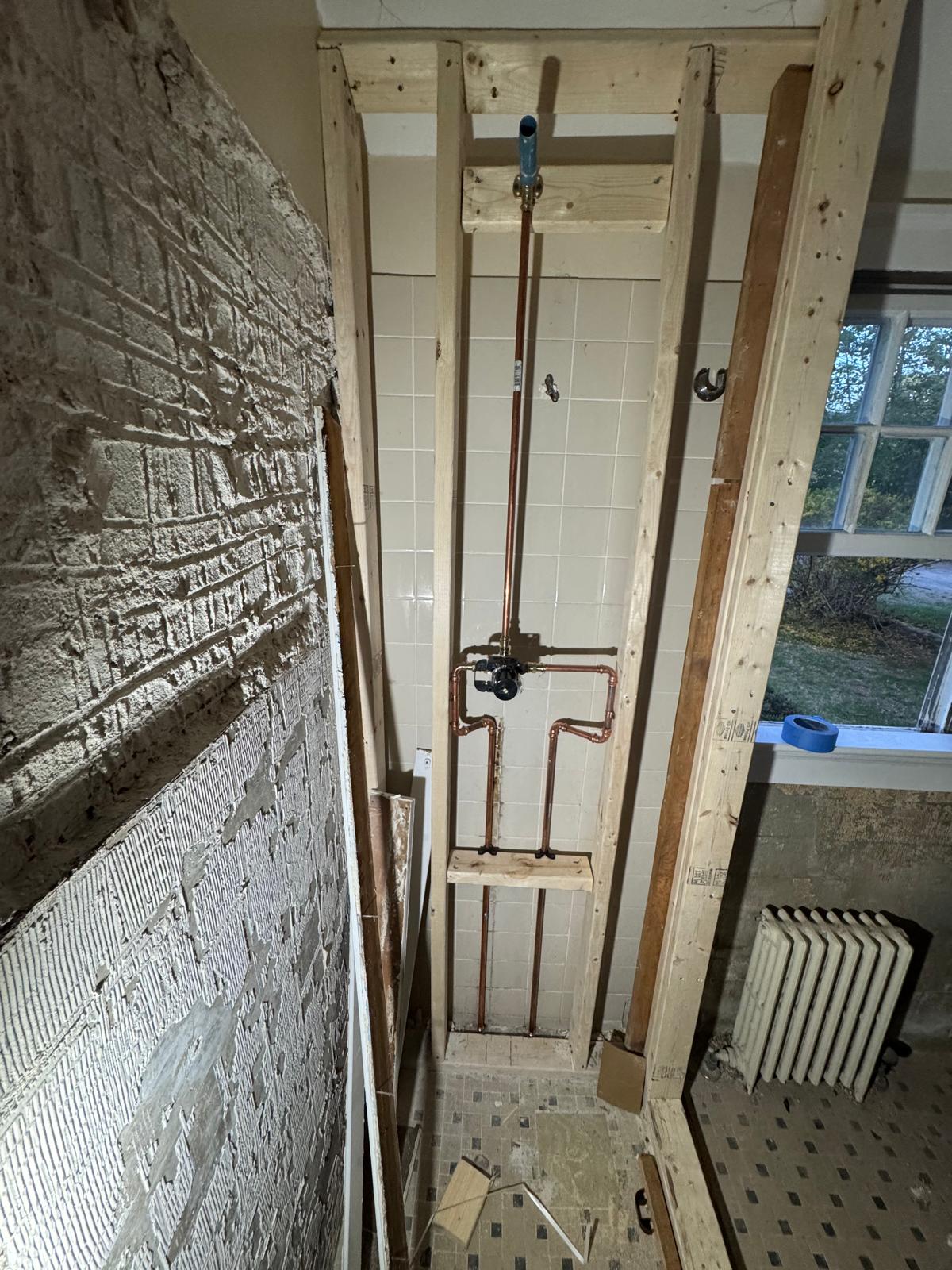 During — old shower removed down to the studs with new copper plumbing